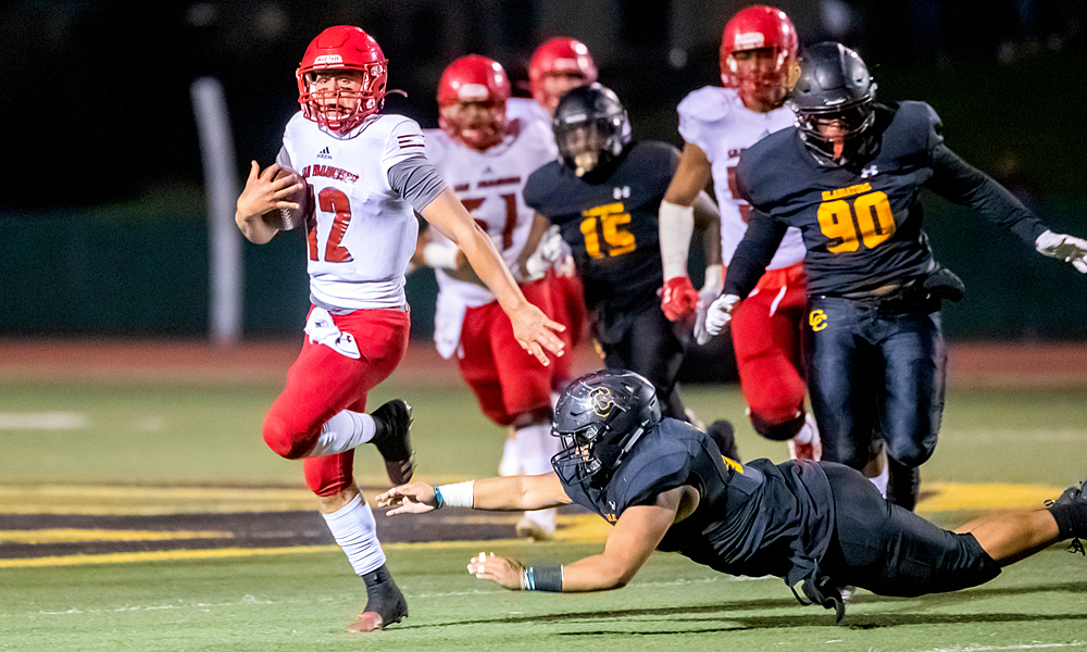 Quarterback Jack Newman evades a tackle in CCSF's win at Chabot. (Photo by Eric Sun)
